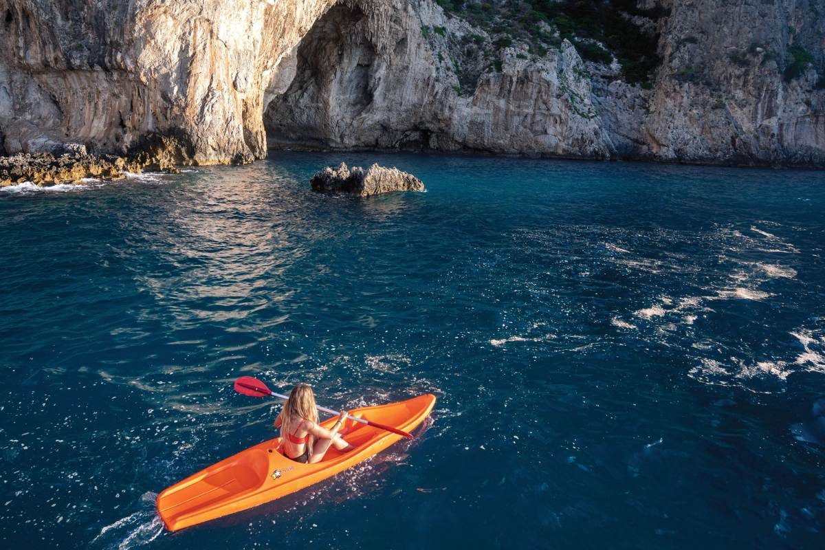 Woman kayaking in Italy during a cruise stop